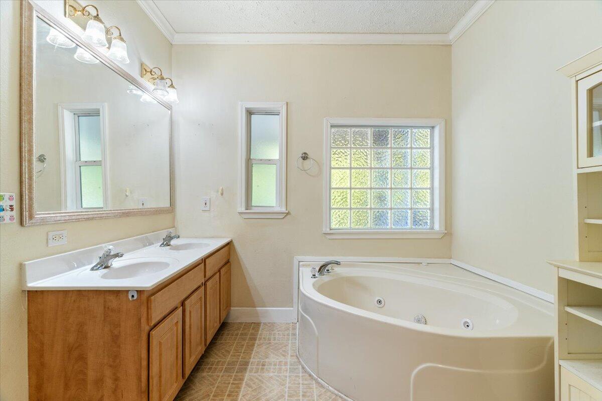 2941 Ferris Drive Navarre, FL 32566 - Photo 14 of 32 a bathroom with a tub a sink and a window