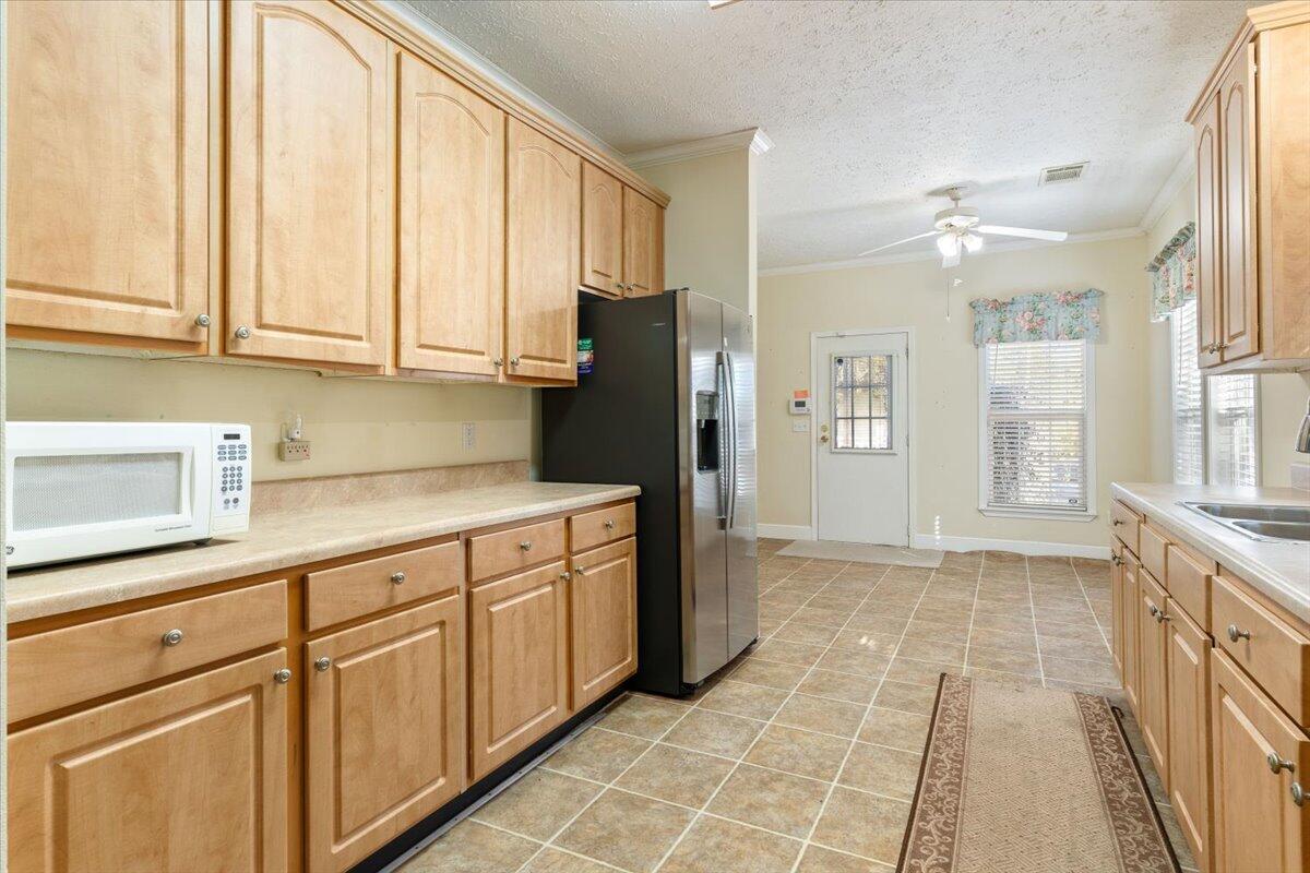 2941 Ferris Drive Navarre, FL 32566 - Photo 20 of 32 a kitchen with stainless steel appliances granite countertop a refrigerator and a sink
