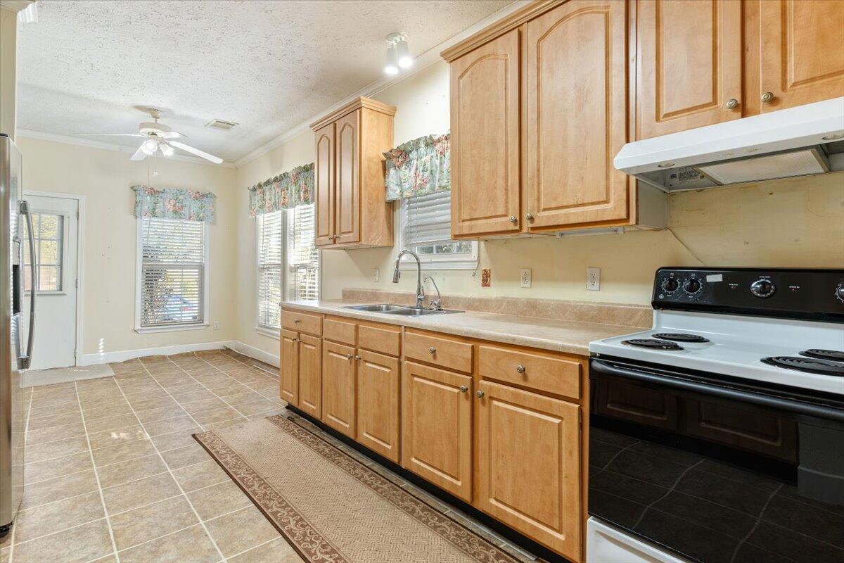 2941 Ferris Drive Navarre, FL 32566 - Photo 21 of 32 a kitchen with stainless steel appliances a sink stove and cabinets