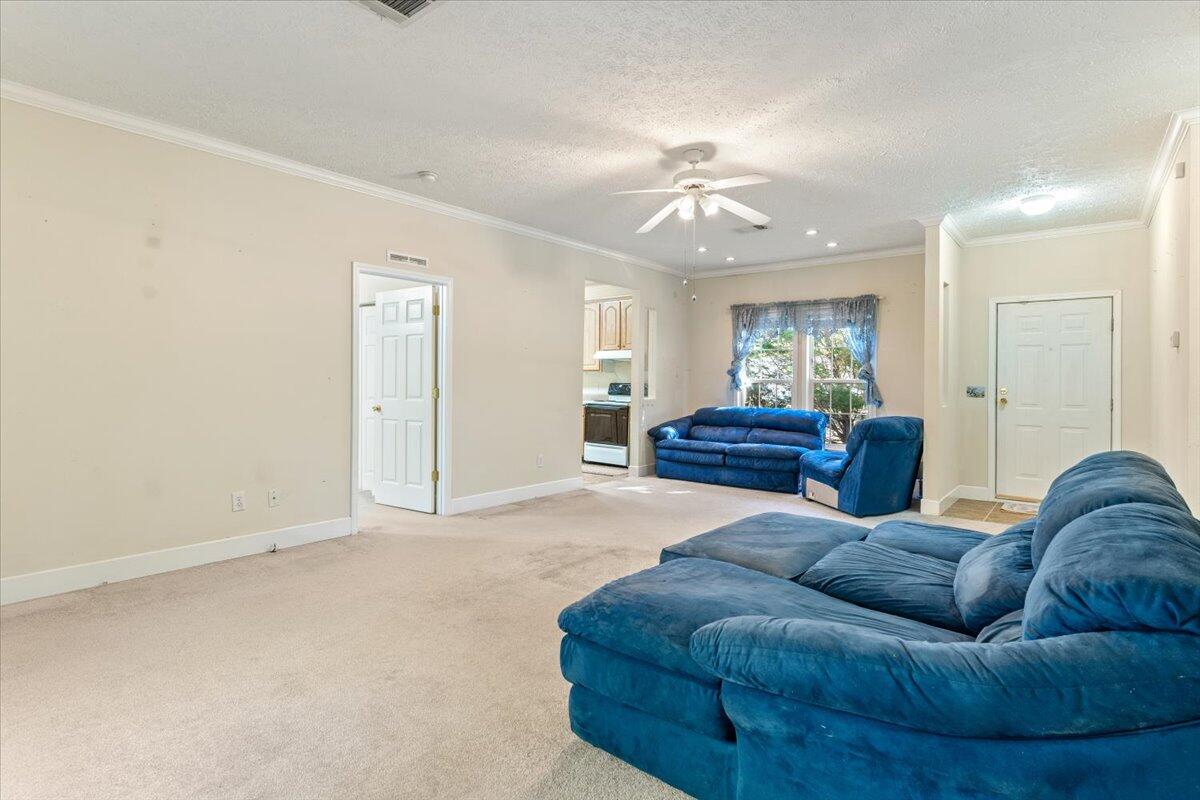 2941 Ferris Drive Navarre, FL 32566 - Photo 7 of 32 a living room with a couch and chandelier