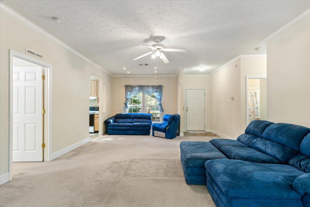 2941 Ferris Drive Navarre, FL 32566 - Photo 8 of 32 a living room with furniture and a ceiling fan