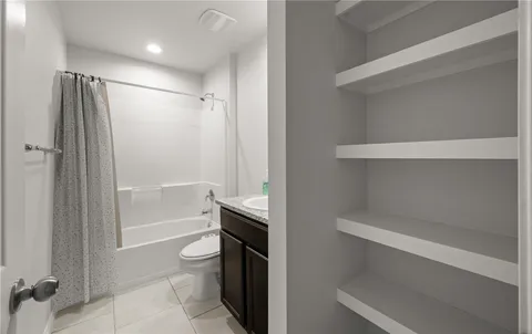 a bathroom with a shower a toilet and a tub