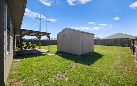 a view of a house with backyard and a sitting area