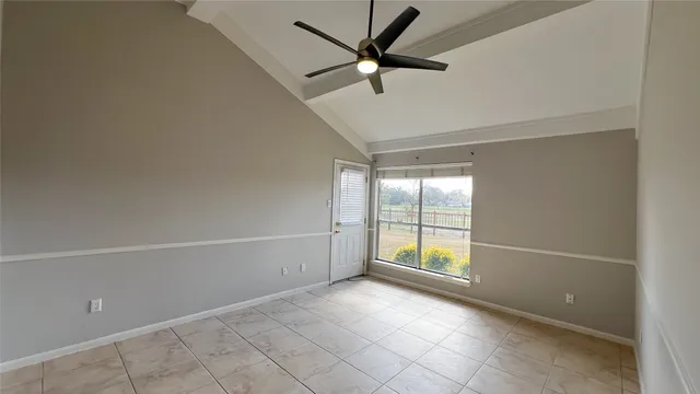 an empty room with windows and view of an empty room