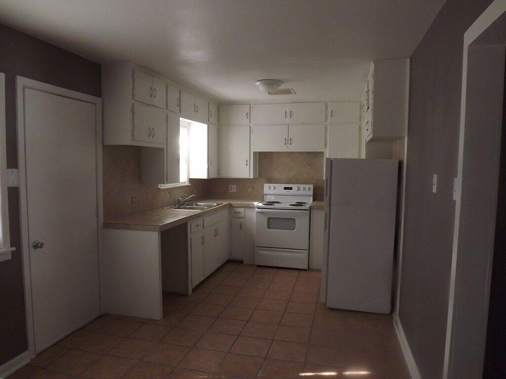 3815 25th Street Lubbock, TX 79410 - Photo 11 of 14 a kitchen with a sink a stove and refrigerator