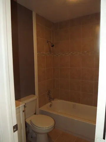 a bathroom with a toilet and shower
