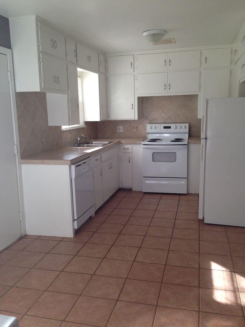 3815 25th Street Lubbock, TX 79410 - Photo 14 of 14 a kitchen with a stove a sink and a refrigerator