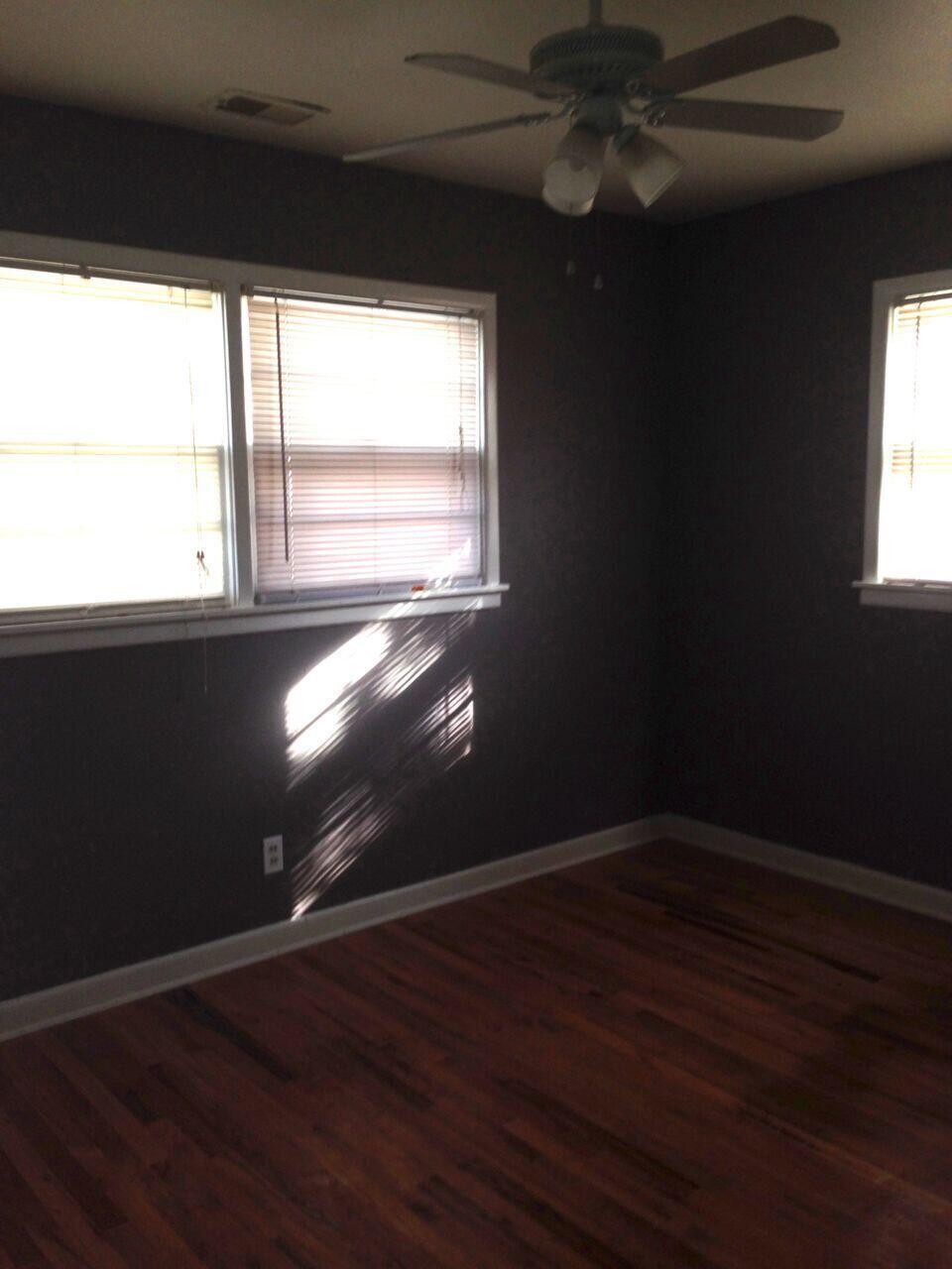 3815 25th Street Lubbock, TX 79410 - Photo 5 of 14 a view of an empty room with wooden floor and a window