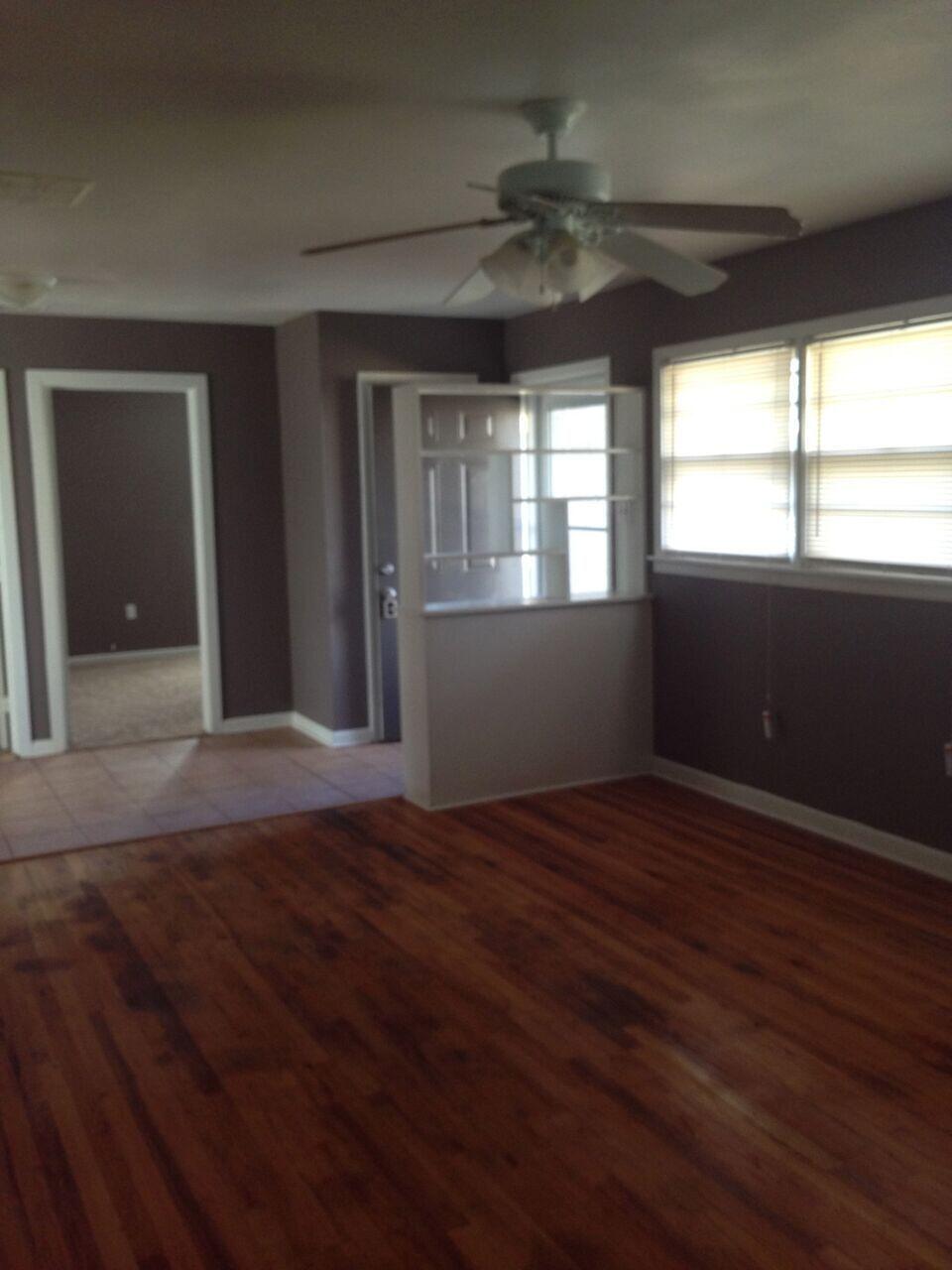 3815 25th Street Lubbock, TX 79410 - Photo 6 of 14 an empty room with wooden floor and windows