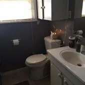 a bathroom with a toilet sink and mirror