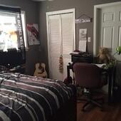 3815 25th Street Lubbock, TX 79410 - Photo 9 of 14 a bedroom with a bed table chair and a window