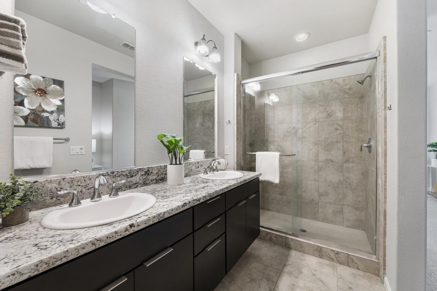 6063 Raleigh Road San Jose, CA 95123 - Photo 19 of 44 a bathroom with a granite countertop sink mirror and a shower