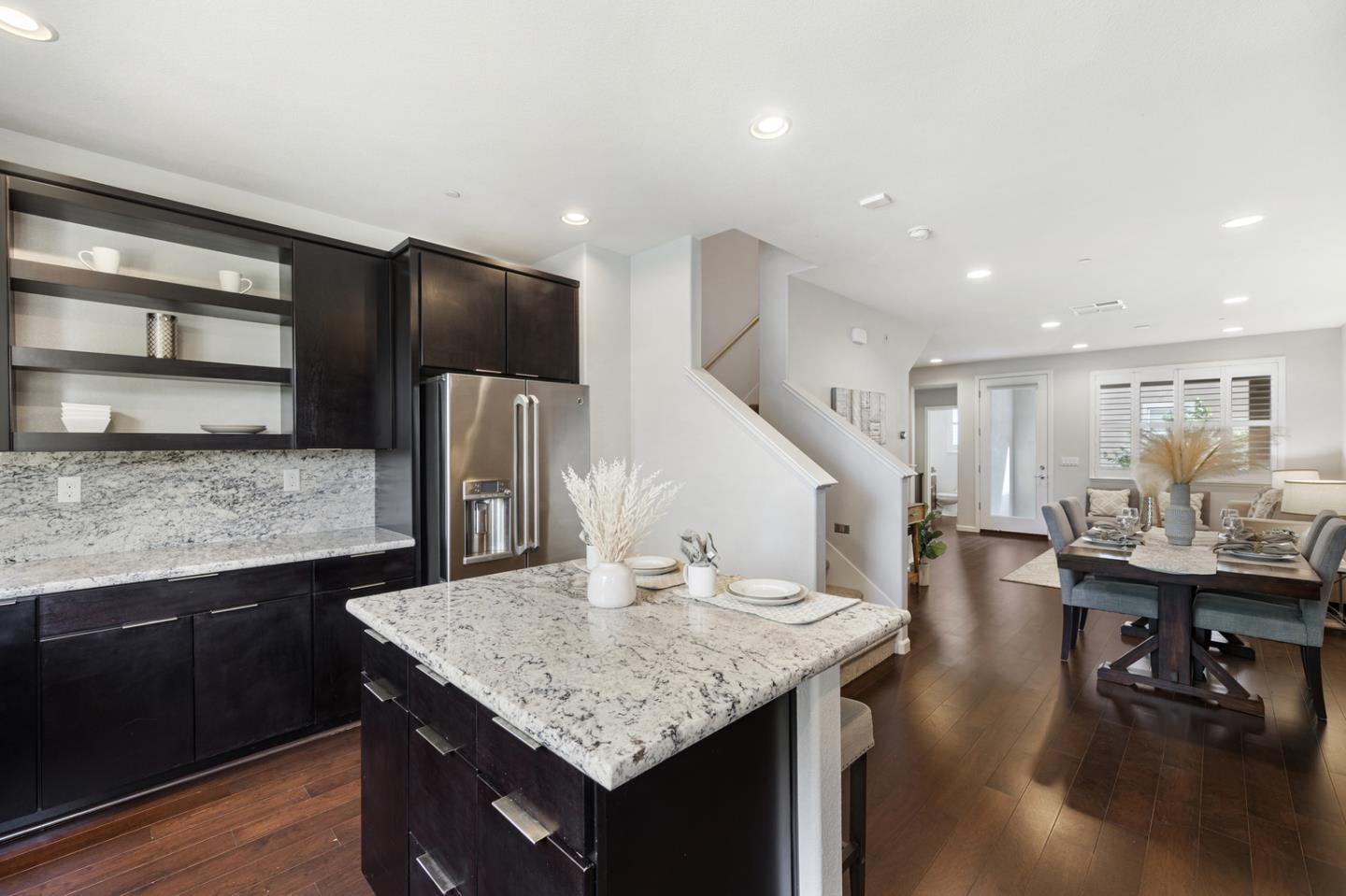 6063 Raleigh Road San Jose, CA 95123 - Photo 4 of 44 a kitchen with stainless steel appliances granite countertop a table chairs and a refrigerator