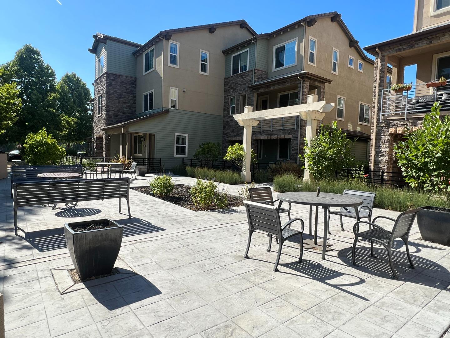6063 Raleigh Road San Jose, CA 95123 - Photo 42 of 44 a view of a patio with table and chairs potted plants and a fire pit