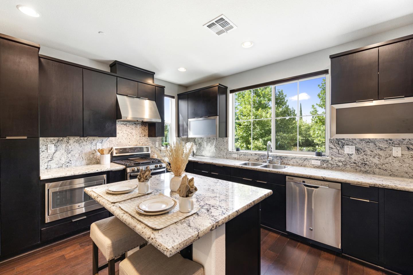 6063 Raleigh Road San Jose, CA 95123 - Photo 6 of 44 a kitchen with a sink and chairs