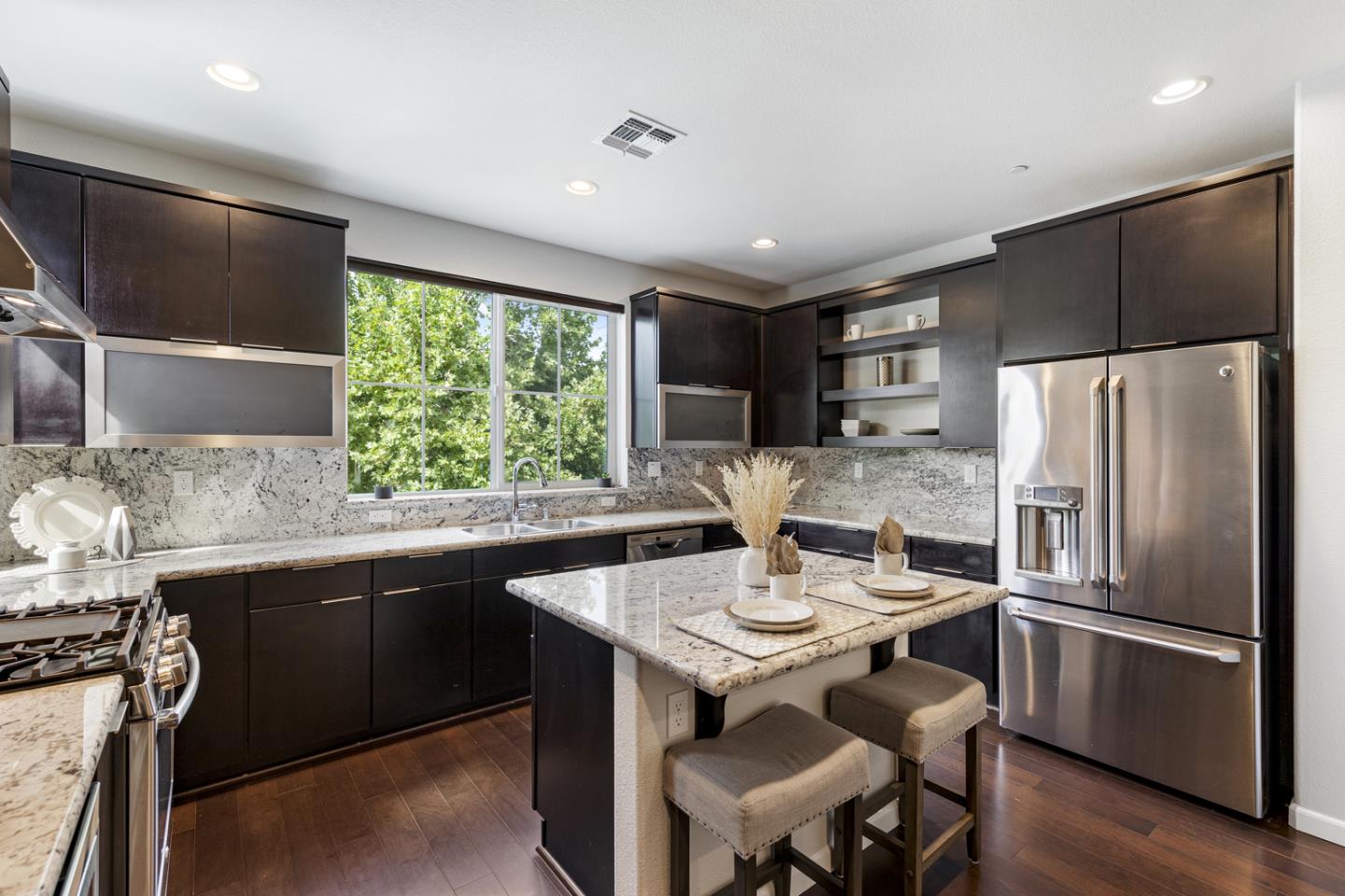 6063 Raleigh Road San Jose, CA 95123 - Photo 7 of 44 a kitchen with stainless steel appliances granite countertop a sink stove and refrigerator
