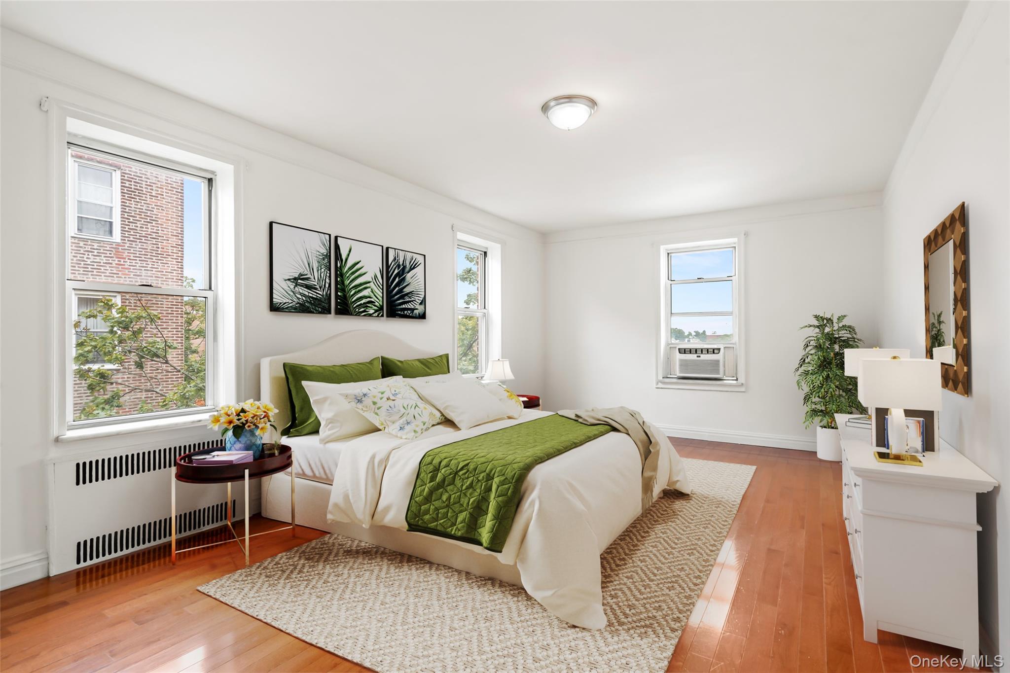 111-39 76th Road, Unit E7 Queens, NY 11375 - Photo 11 of 23 a bedroom with a large bed couch and a window