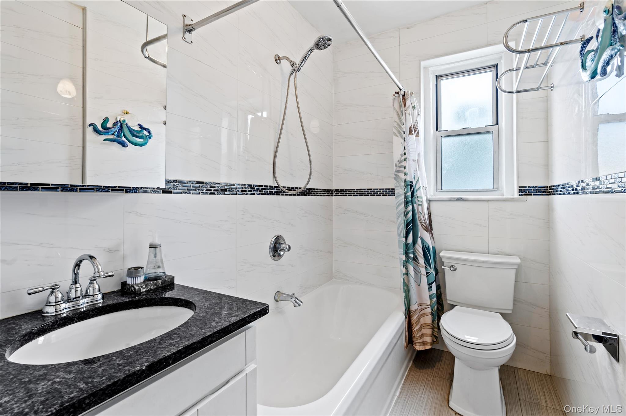 111-39 76th Road, Unit E7 Queens, NY 11375 - Photo 14 of 23 a bathroom with a granite countertop sink mirror vanity and toilet