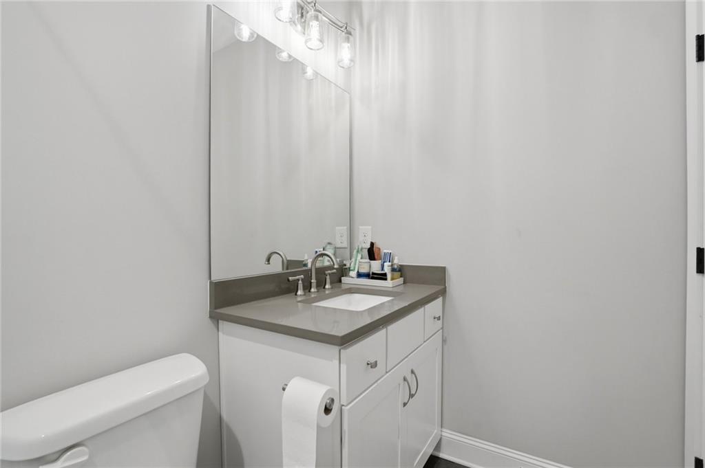 3020 Wallace Road Buford, GA 30519 - Photo 39 of 66 a bathroom with a granite countertop sink and a toilet