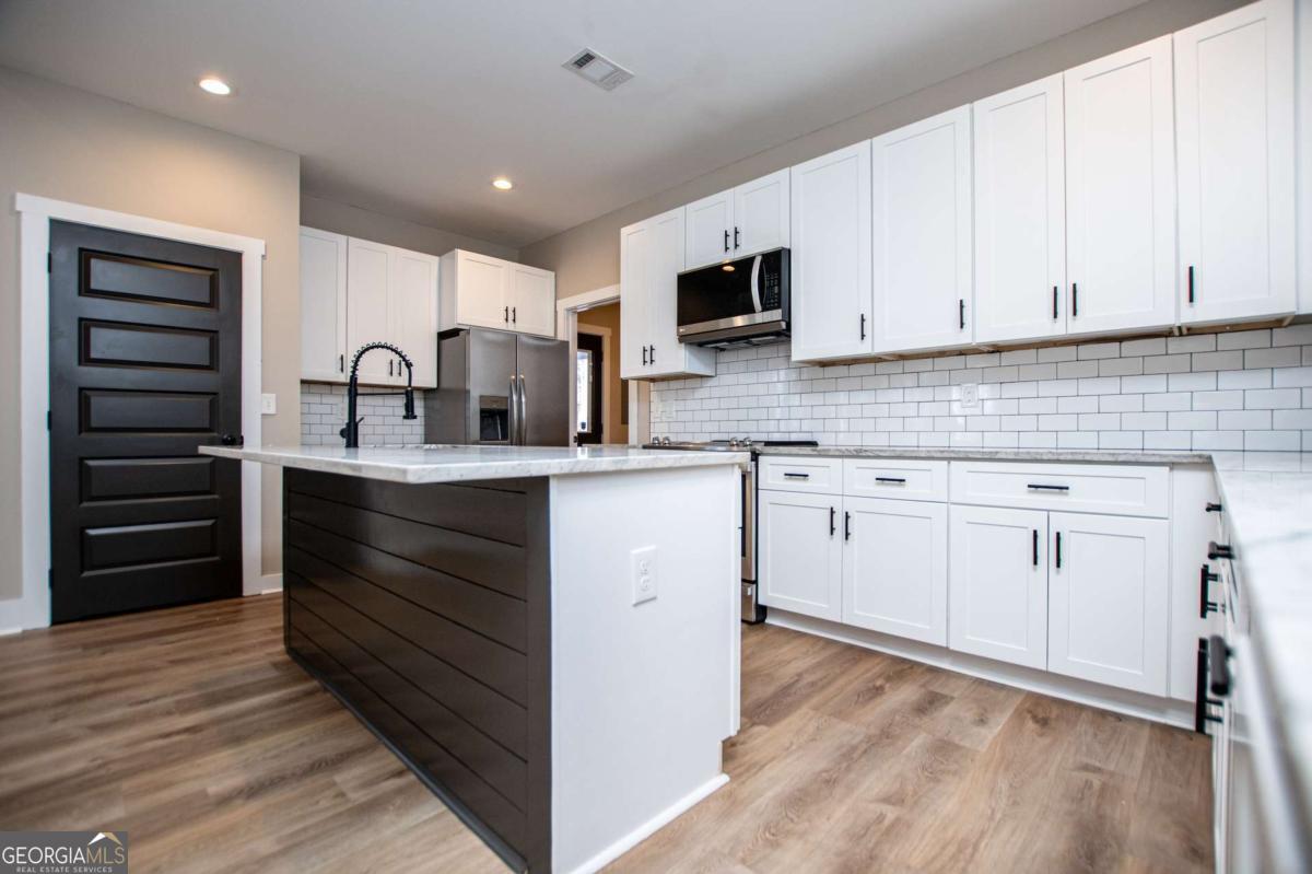 1605 5 Points Road Waco, GA 30182 - Photo 13 of 61 a kitchen with cabinets appliances and a counter space