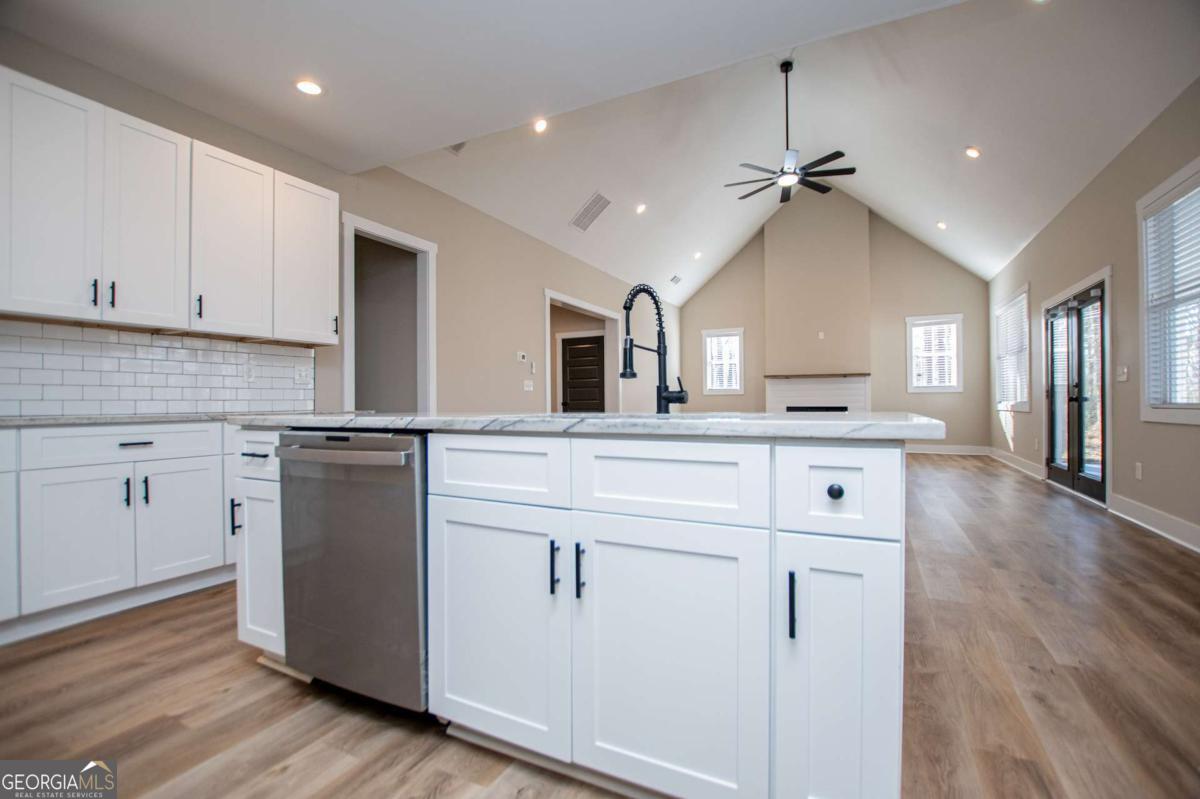 1605 5 Points Road Waco, GA 30182 - Photo 15 of 61 a kitchen with kitchen island white cabinets and refrigerator