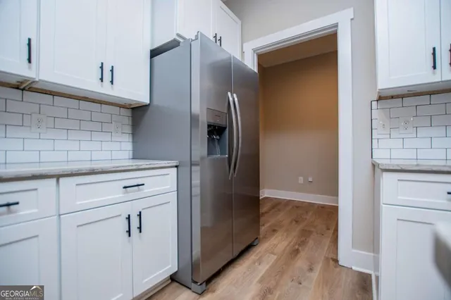 a kitchen with stainless steel appliances a refrigerator and cabinets