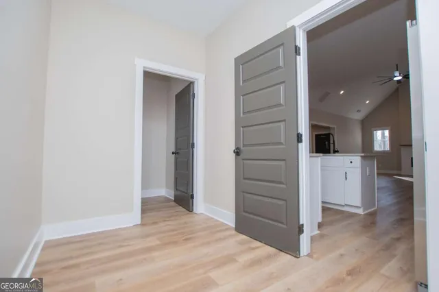 a bedroom with a bed and a potted plant on the dresser