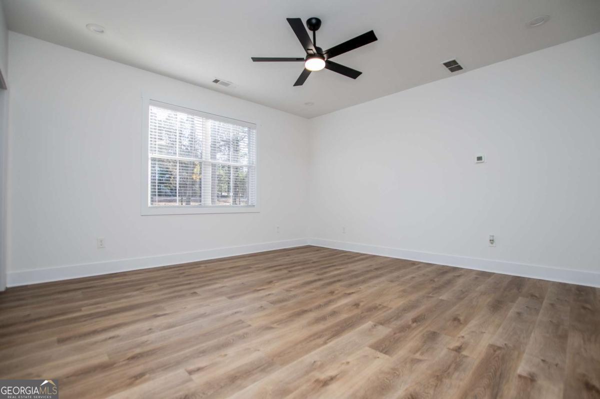1605 5 Points Road Waco, GA 30182 - Photo 20 of 61 a view of empty room with wooden floor and fan