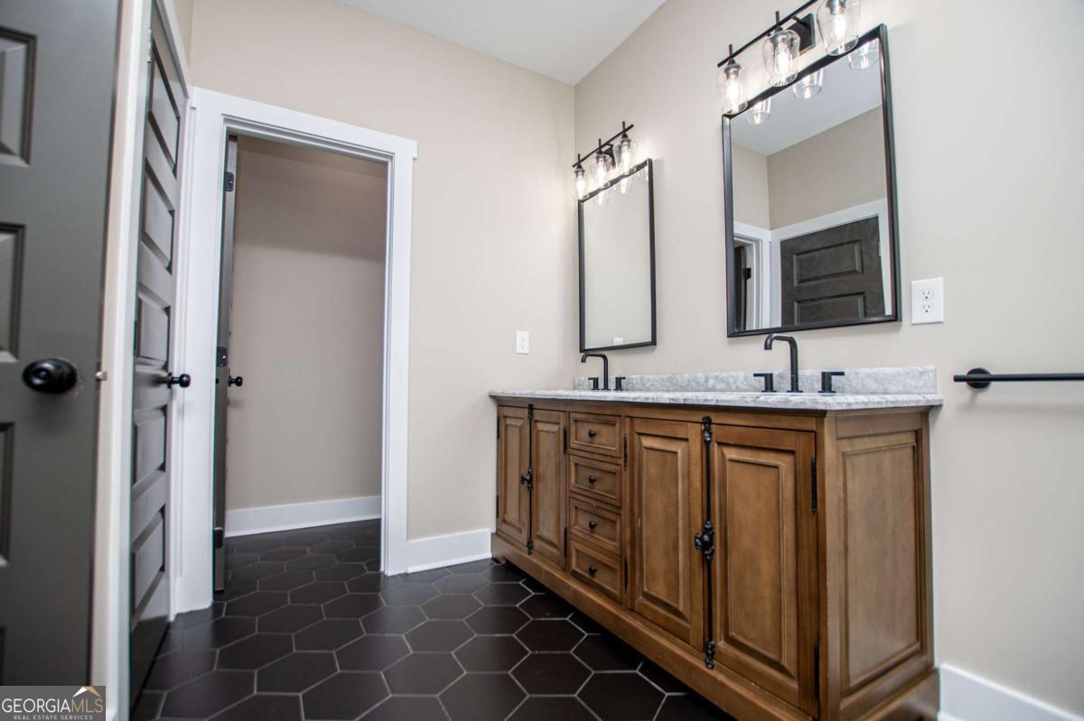 1605 5 Points Road Waco, GA 30182 - Photo 25 of 61 a bathroom with double vanity sink and a mirror