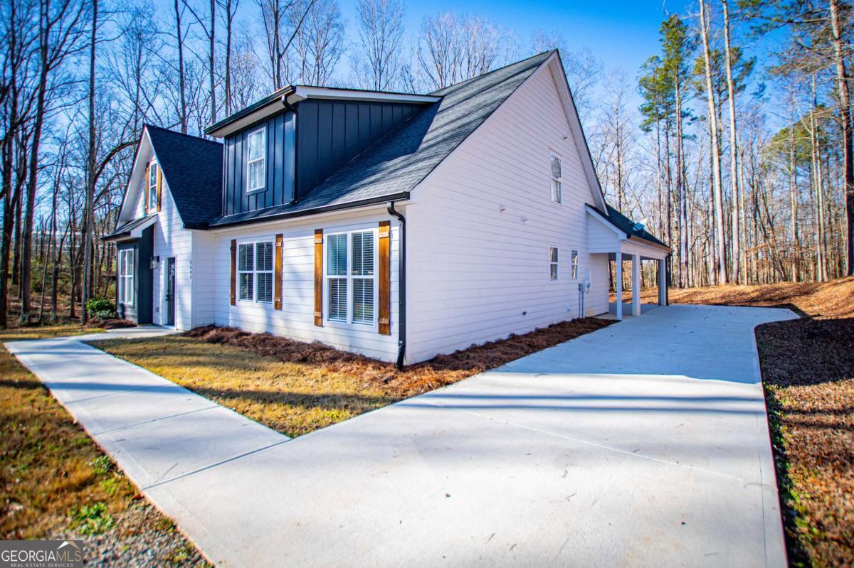 1605 5 Points Road Waco, GA 30182 - Photo 3 of 61 a view of a house with backyard and trees