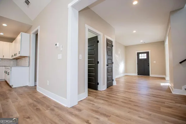 a view of entryway and hall with wooden floor
