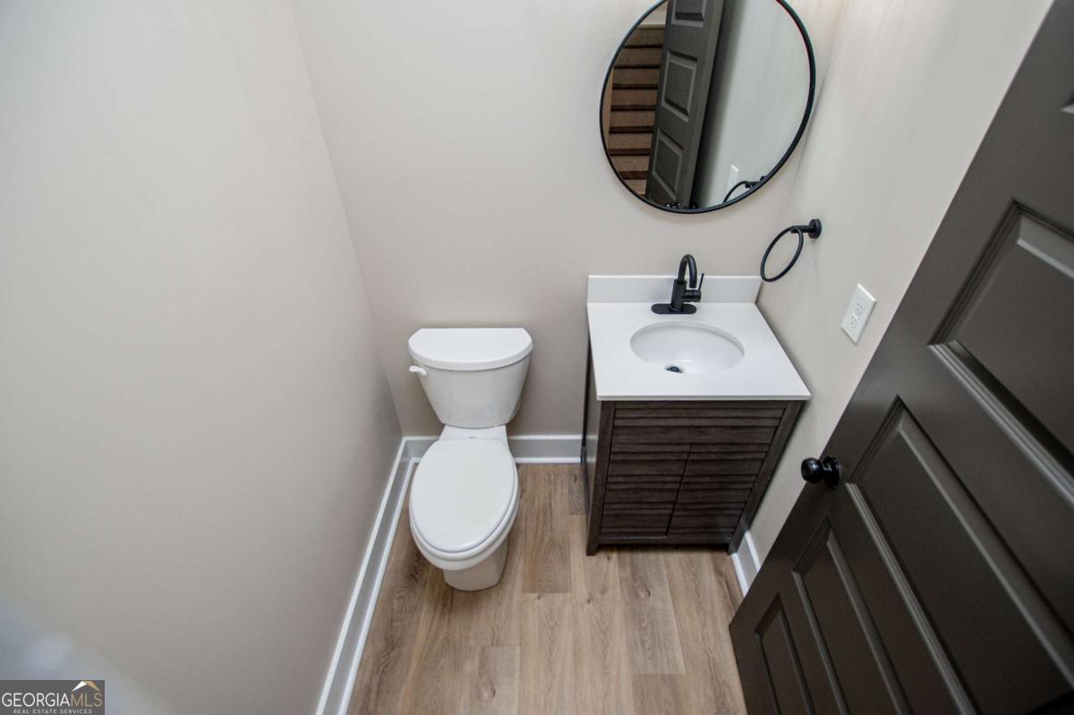 1605 5 Points Road Waco, GA 30182 - Photo 32 of 61 a bathroom with a toilet a sink and a mirror