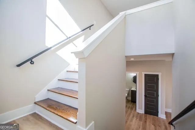 a bathroom with a granite countertop sink a toilet and bathtub