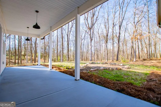 a view of a house with a bed and wooden fence