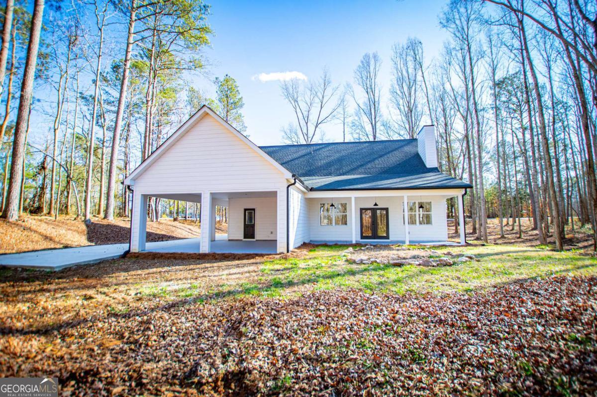 1605 5 Points Road Waco, GA 30182 - Photo 53 of 61 a front view of a house with a yard and trees