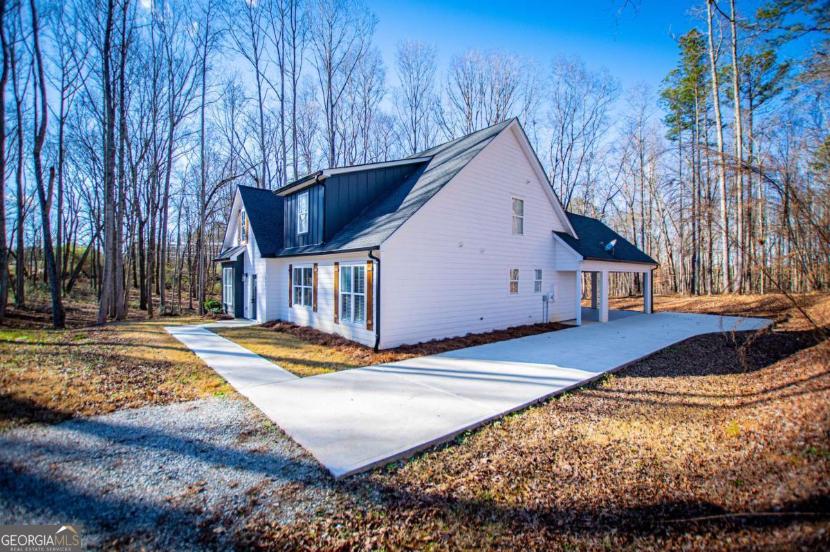 1605 5 Points Road Waco, GA 30182 - Photo 55 of 61 a view of a house with snow on the road