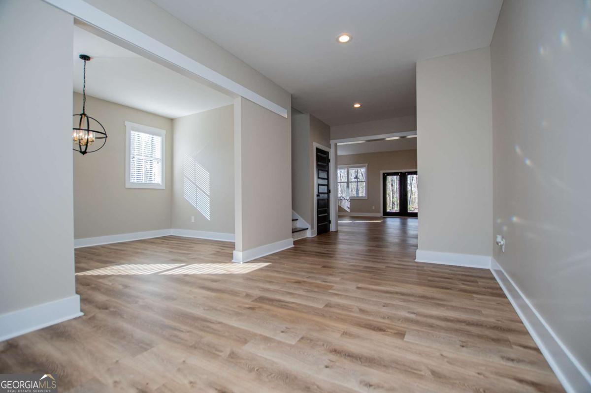 1605 5 Points Road Waco, GA 30182 - Photo 8 of 61 a view of a hallway with wooden floor and a living room