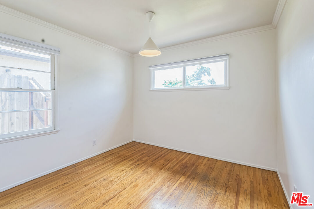 12753 Appleton Way Los Angeles, CA 90066 - Photo 21 of 31 a view of empty room with wooden floor and fan