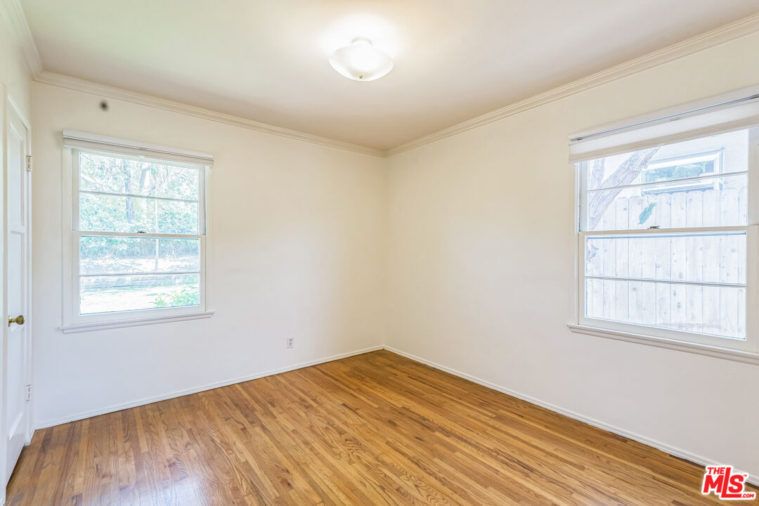 12753 Appleton Way Los Angeles, CA 90066 - Photo 23 of 31 an empty room with wooden floor and windows