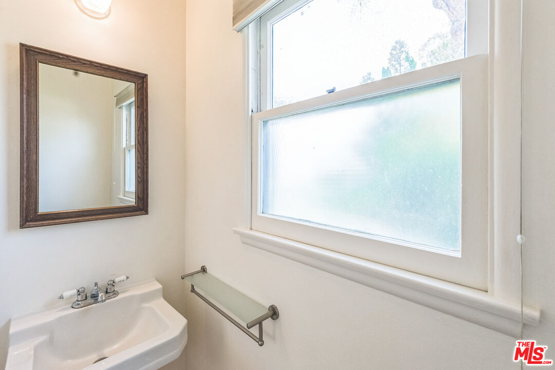 12753 Appleton Way Los Angeles, CA 90066 - Photo 27 of 31 a bathroom with a sink and a mirror