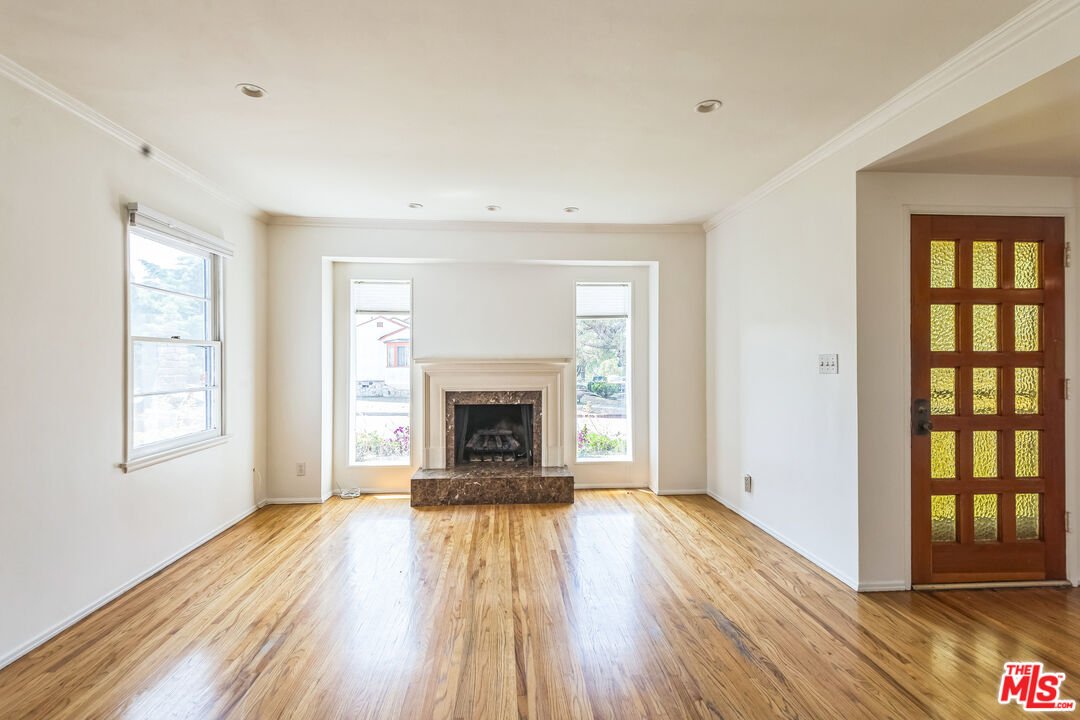 12753 Appleton Way Los Angeles, CA 90066 - Photo 3 of 31 a view of empty room with wooden floor and fireplace