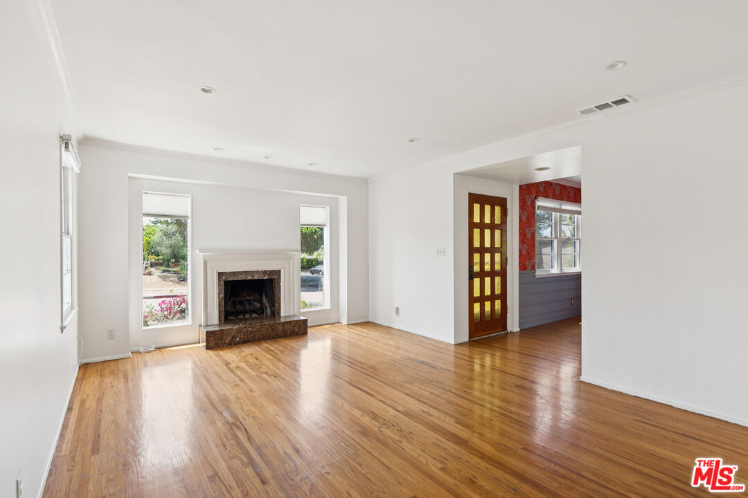 12753 Appleton Way Los Angeles, CA 90066 - Photo 4 of 31 a view of an empty room with wooden floor fireplace and a window