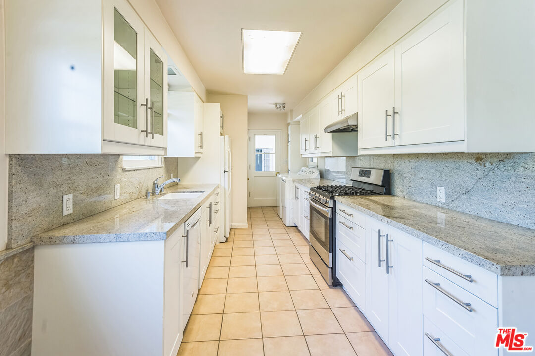 12753 Appleton Way Los Angeles, CA 90066 - Photo 8 of 31 a large kitchen with stainless steel appliances granite countertop a sink and cabinets