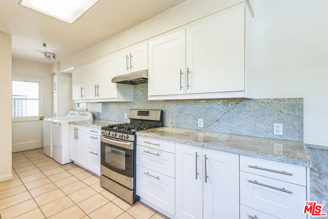 12753 Appleton Way Los Angeles, CA 90066 - Photo 9 of 31 a kitchen with granite countertop white cabinets and white appliances