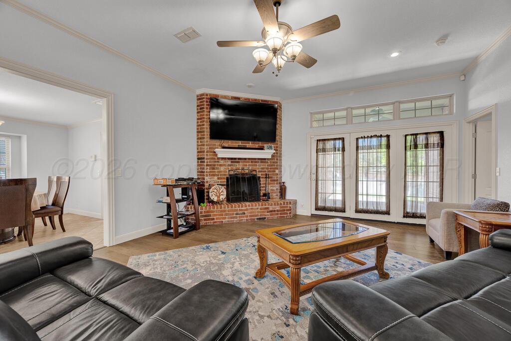 6604 Pepper Tree Place Amarillo, TX 79124 - Photo 11 of 28 a living room with furniture fireplace and a flat screen tv