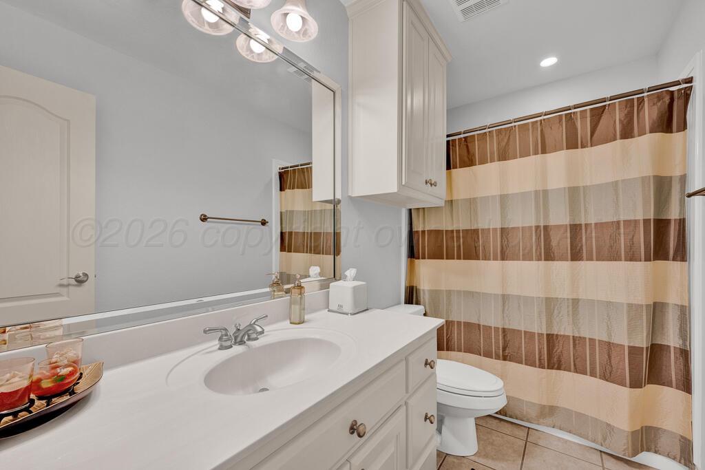 6604 Pepper Tree Place Amarillo, TX 79124 - Photo 18 of 28 a bathroom with a sink a toilet and shower