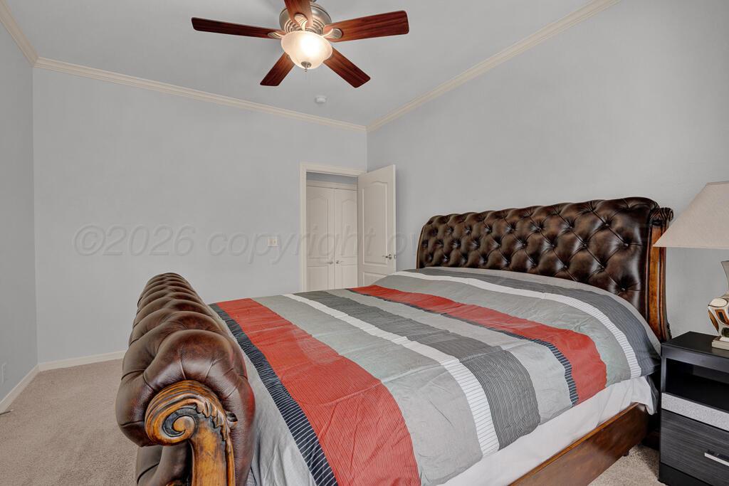 6604 Pepper Tree Place Amarillo, TX 79124 - Photo 20 of 28 a bedroom with a bed and a chandelier