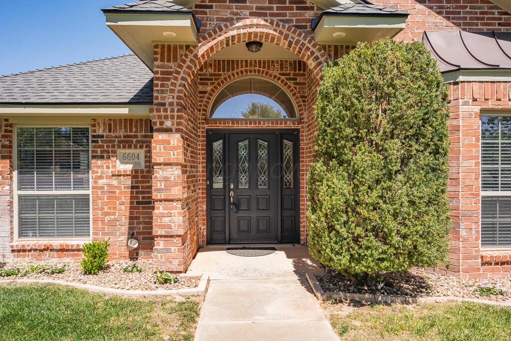 6604 Pepper Tree Place Amarillo, TX 79124 - Photo 2 of 28 a front view of a house with a yard