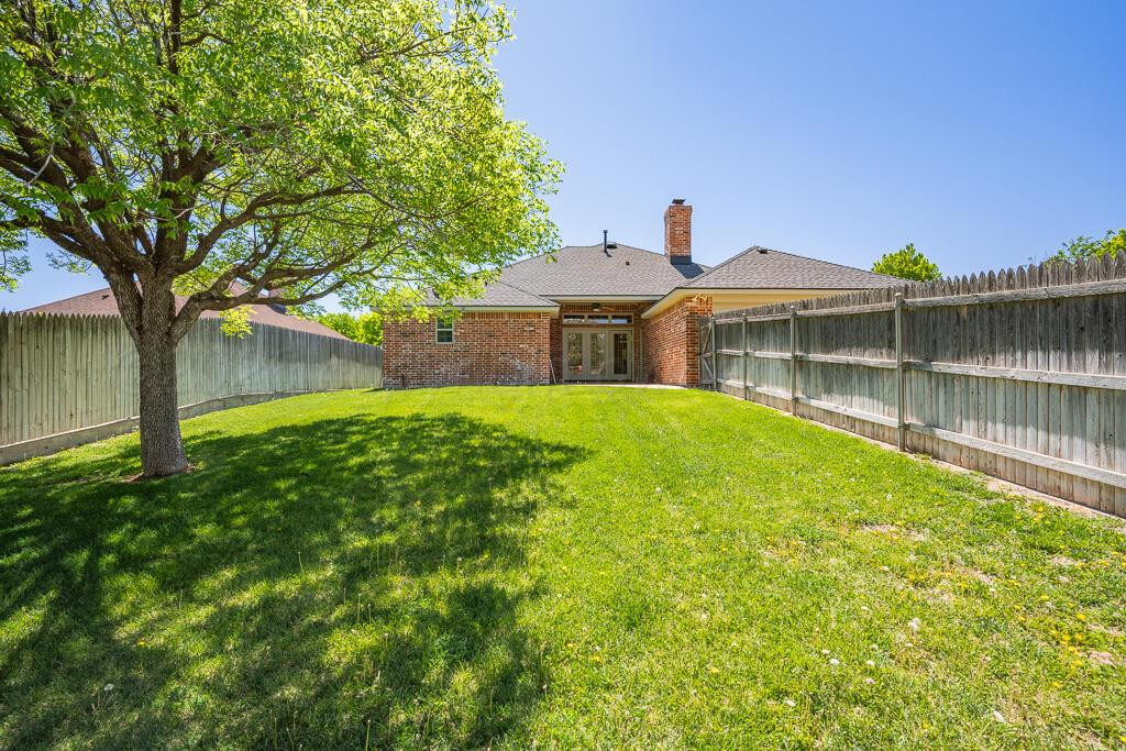 6604 Pepper Tree Place Amarillo, TX 79124 - Photo 24 of 28 a view of a house with a big yard and large trees