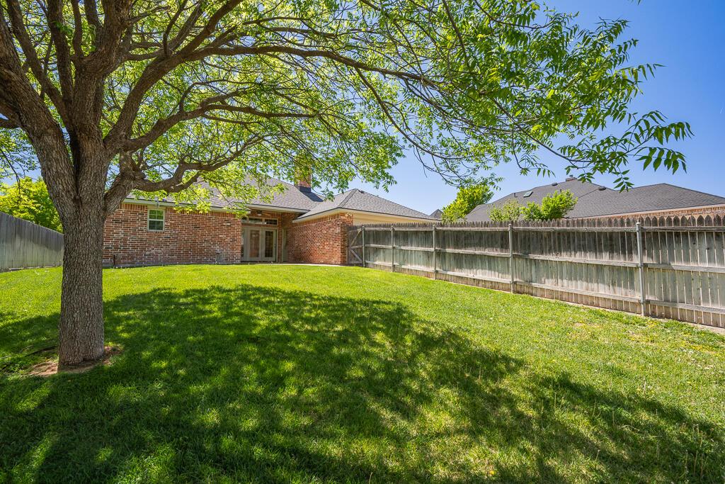 6604 Pepper Tree Place Amarillo, TX 79124 - Photo 25 of 28 a front view of house with yard and green space